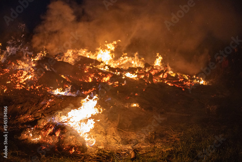 Obraz na plátně Bonfire at Traditional Easter fire event with flames and community gathering