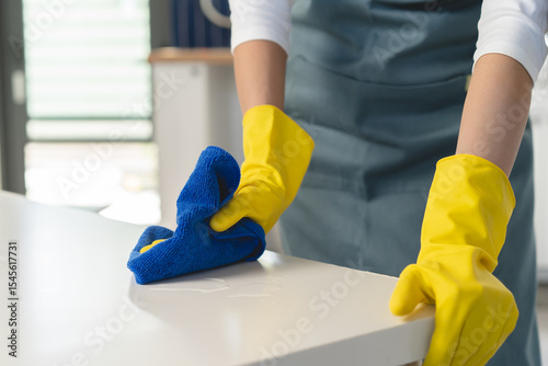 Close-up woman use small towel cleaning kitchen