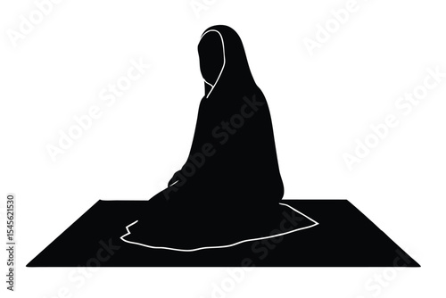 Silhouette of woman in burqa praying on a mat