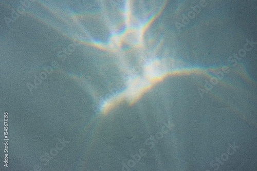 Blurred water texture overlay effect for photo and mockups. Organic drop diagonal shadow and light caustic effect on a white wall. Shadows for natural light effects