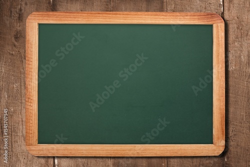 Framed green chalkboard resting against rustic plank backdrop in flat design, showing blank surface