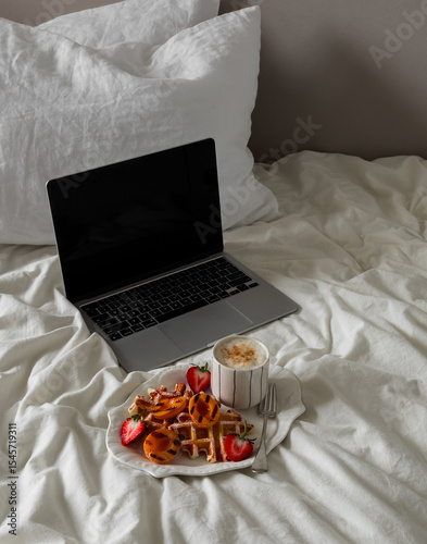 Lazy morning - laptop and breakfast in bed. Waffles with fruit and cappuccino