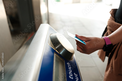 Woman using credit card to pay public transport fare