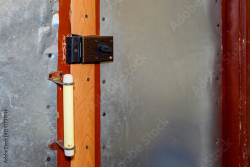 Obraz na plátně padlock on the entrance door to the apartment, wooden door covered with metal