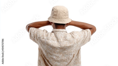 A man wearing a hat with his hands behind his head