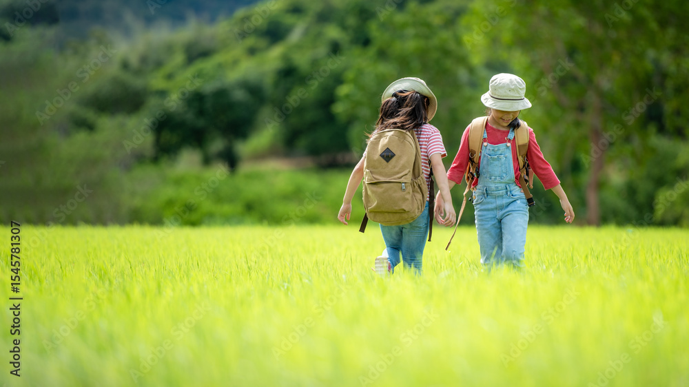 Obraz premium Group family children checking map in the jungle adventure. Asia people tourism for destination leisure trips for education and relax in nature park. Mountain background