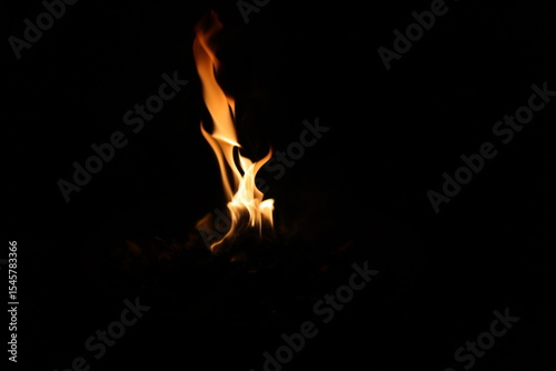 Fire flames on black background. Closeup of fire flames isolated on black background