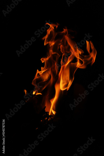 Fire flames on black background. Closeup of fire flames isolated on black background