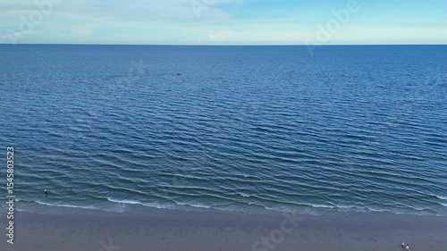Empty tropical beach and still sea from drone