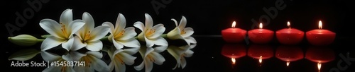 White lilies & burning candles reflected on a black, polished surface Dark background , reflection, sacred