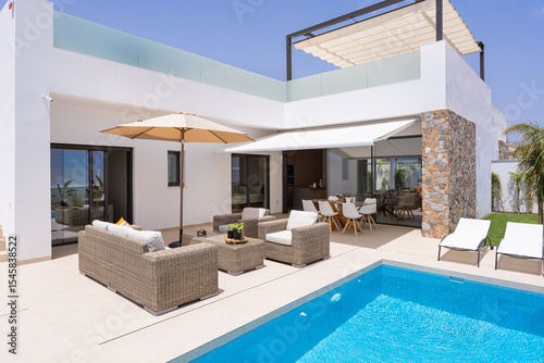 Modern villa terrace with pool and outdoor seating