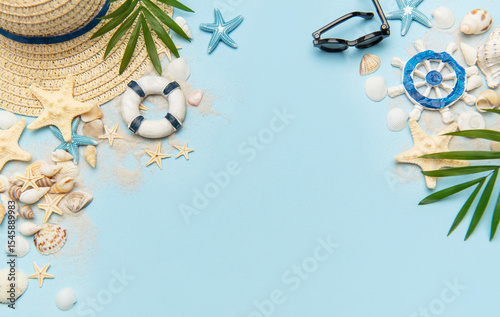 Summer vacation accessories creating a frame on blue background