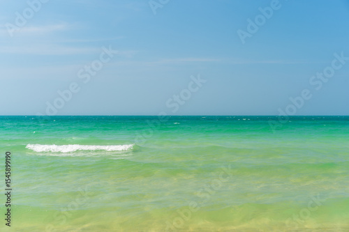 seascape skyline and skyscape background by sea beach with little white waves to clear and clean ocean marine water and nature blue sky daylight for summer holiday travel at Sai Kaew Beach Thailand