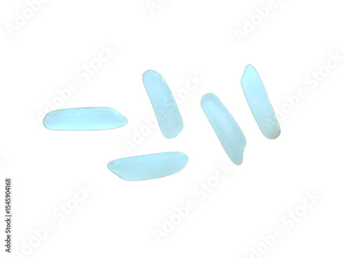 Five grains of white rice scattered randomly, each elongated and smooth with a slightly translucent appearance.