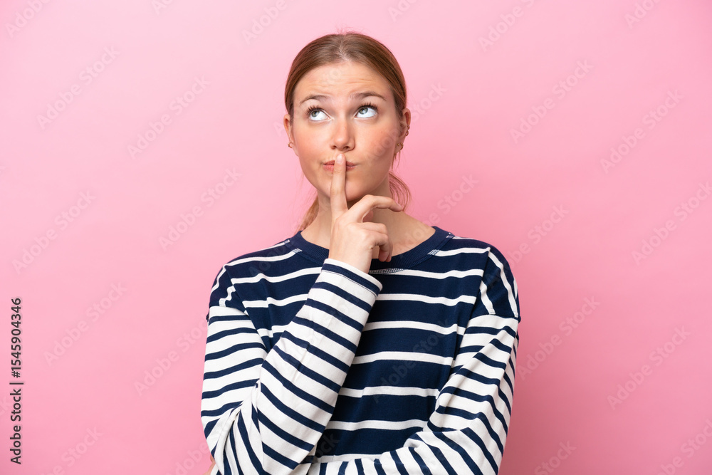Young caucasian woman isolated on pink background having doubts while looking up Young caucasian woman isolated on pink background having doubts while looking up