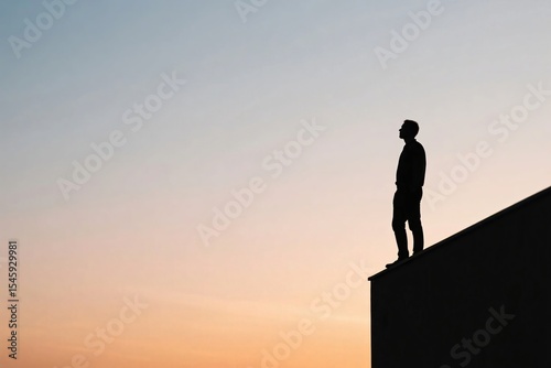 Silhouette of Man Standing on Rooftop at Night
