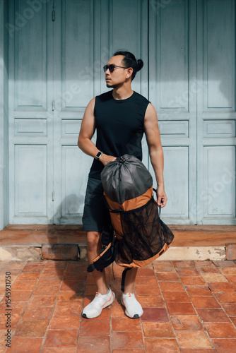 Tourist backpacker man waiting for taxi in Asia old town.