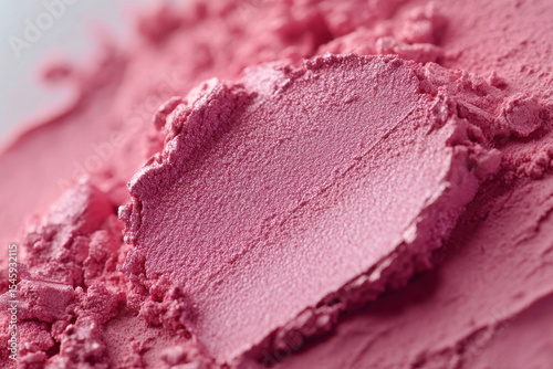 Close up of pink powder makeup, possibly blush or eyeshadow, with soft texture and vibrant color. image highlights fine details and smooth surface of cosmetic product