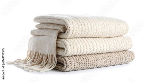 Stacked cozy warm knitted blankets with white background.