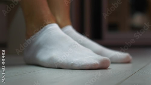 Wallpaper Mural Man sitting on the floor in white socks.
Male legs and white short socks.
Man's feet are cold and he puts on socks.
Male foot on the floor Torontodigital.ca