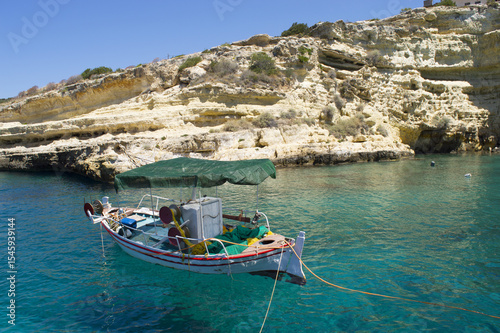 Fototapeta Naklejka Na Ścianę i Meble -  Summer in Greece,Gorgeous nature bay with clear blue waters and old fishing boat floating.Mani Peloponnese 