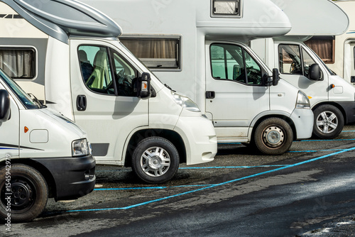 campers and motorhomes on asphatl parning, white auto caravan for  vacation travel