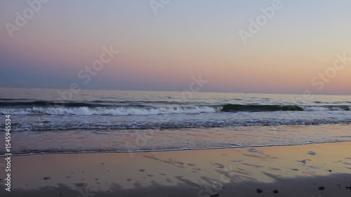 Wallpaper Mural Coastal Serenity: Capturing the tranquil moment as gentle waves caress the sandy shore under a soft, colorful sunset sky. Evoking calmness and serenity. Torontodigital.ca