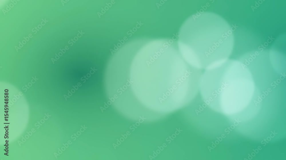 Dreamy green abstract background with soft bokeh light circles, creating a tranquil and blurred shimmering atmosphere.