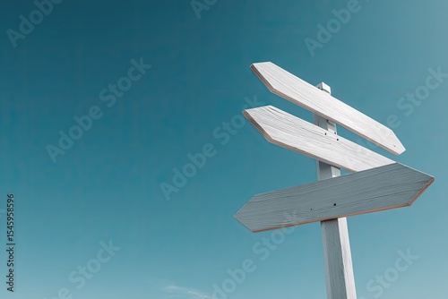 Wallpaper Mural Three blank white wooden directional arrows against a clear teal sky, signifying choices and direction Torontodigital.ca