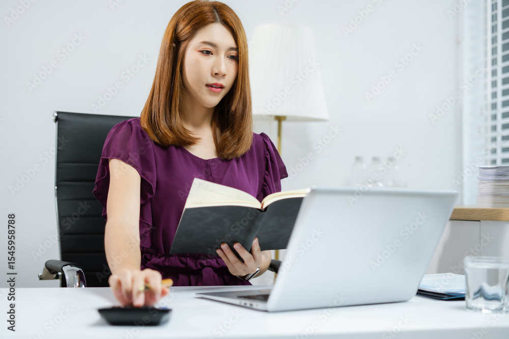 Female businessman working on desk office with using a calculator to calculate cost business report talk smart phone on office desk, finance accounting concept. Female businessman working on desk office with using a calculator to calculate cost business report talk smart phone on office desk, finance accounting concept.