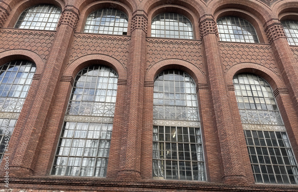 Obraz premium Facade of a typical house with brick walls and arched windows