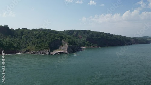 Oddicombe, South Devon, England: DRONE VIEWS: The drone flies in towards the coastline and limestone cliffs overlooking Oddicombe beach. South Devon is a popular UK holiday destination.