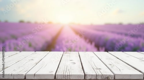 Rustic white wooden table with blooming lavender field in soft focus. Ideal for nature, Provence, or floral background themes