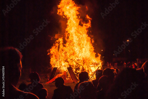 Silhouettes of people at a St. John's bonfire