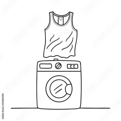 A rumpled undershirt lying on a washing machine top