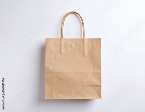 Simple brown paper bag with twisted handles against a clean white background