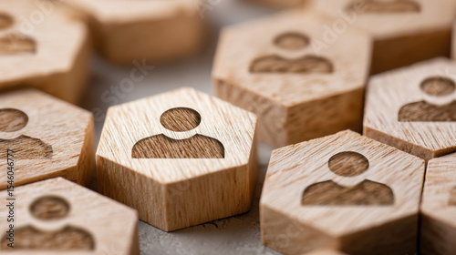 Wooden hexagons with person icons representing teamwork collaboration or human resources.
