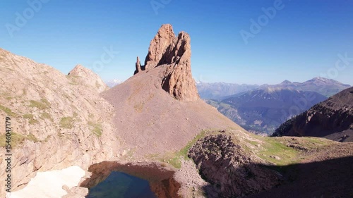 4K drone footage of Agujas de Lavasar and Ibón de Lavasar in the Pyrenees of Aragón, rugged alpine landscape in Chistau Valley with panoramic mountain views in the Cotiella Massif, Spain
