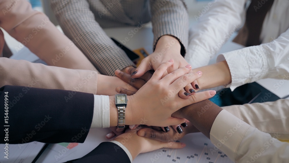 Obraz premium African American Japanese Hispanic multiethnic business women females team girls coworkers businesswomen hands arms folded in unity gesture cooperation teamwork partnership documents table at office