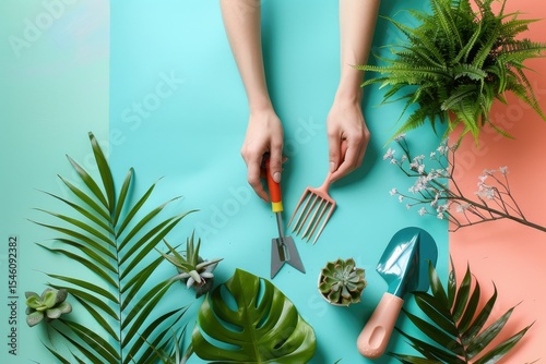 Ultra Quality Picture of Female Hands with Gardening Tools and Houseplant on Color Background