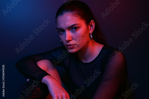 Dramatic Female Portrait with Intense Colored Lighting and Moody Expression