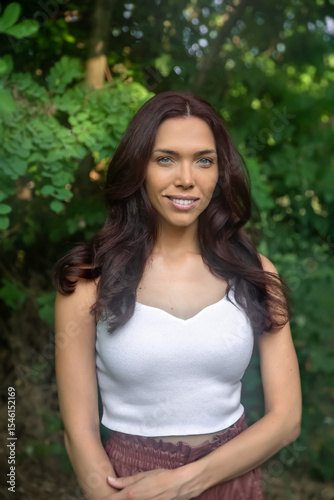 Smiling brunette woman portrait in nature