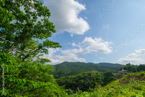 山の上の風力発電の風車｜自然と調和する再生可能エネルギーのある風景 | Wind Turbines on Mountain Ridge — Landscape of Renewable Energy in Harmony with Nature