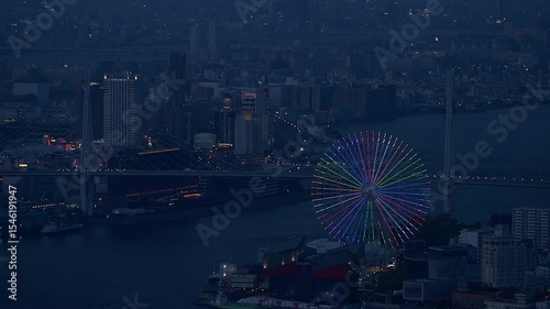Aerial view of the Osaka Bay harbor area with the ferris wheel at night.
