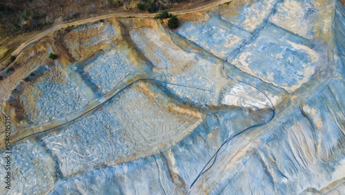 Aerial view of Tsar Asen Mine, Bulgaria – striking patterns of mineral-rich rock layers from a former copper and non-ferrous metal mine. A vivid landscape shaped by years of extraction.