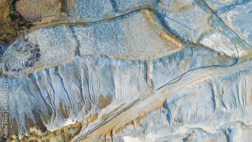 Aerial view of Tsar Asen Mine, Bulgaria – striking patterns of mineral-rich rock layers from a former copper and non-ferrous metal mine. A vivid landscape shaped by years of extraction.