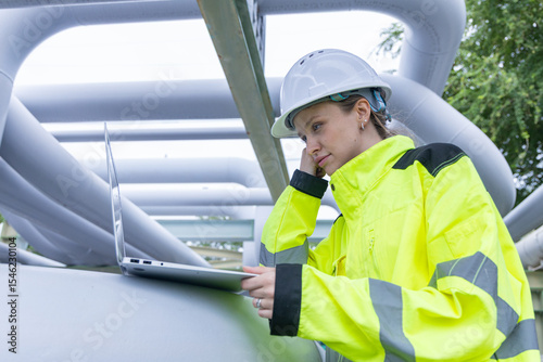 Engineers Analyzing Industrial Piping System Onsite