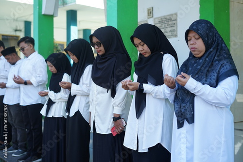 Group of Muslim Students in Prayer  A Moment of Reflection and Faith