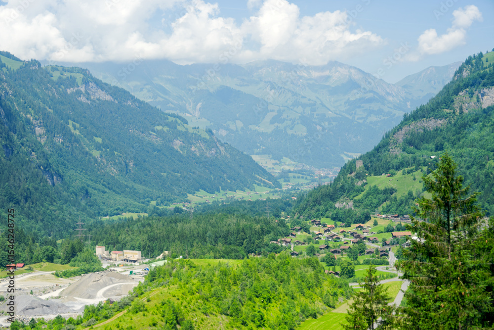 Obraz premium Scenic view of alpine mountain panorama at village of Kandersteg on a sunny spring afternoon. Photo taken June 19th, 2025, Kandersteg, Switzerland. 