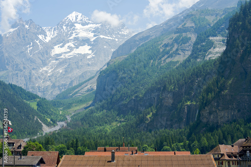 Scenic view of alpine mountain panorama at village of Kandersteg on a sunny spring afternoon. Photo taken June 19th, 2025, Kandersteg, Switzerland.                               
